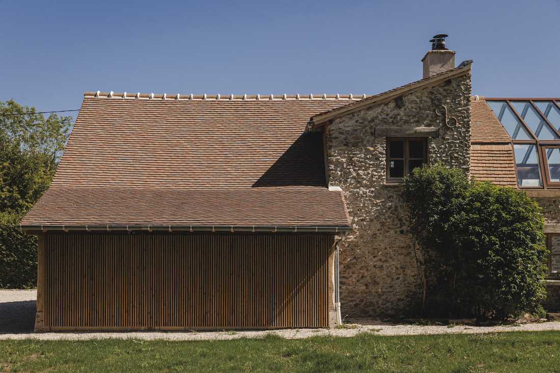 Création d’une piscine dans le jardin d’une longère - le local technique de la piscine habillé d'une claire-voie en bois