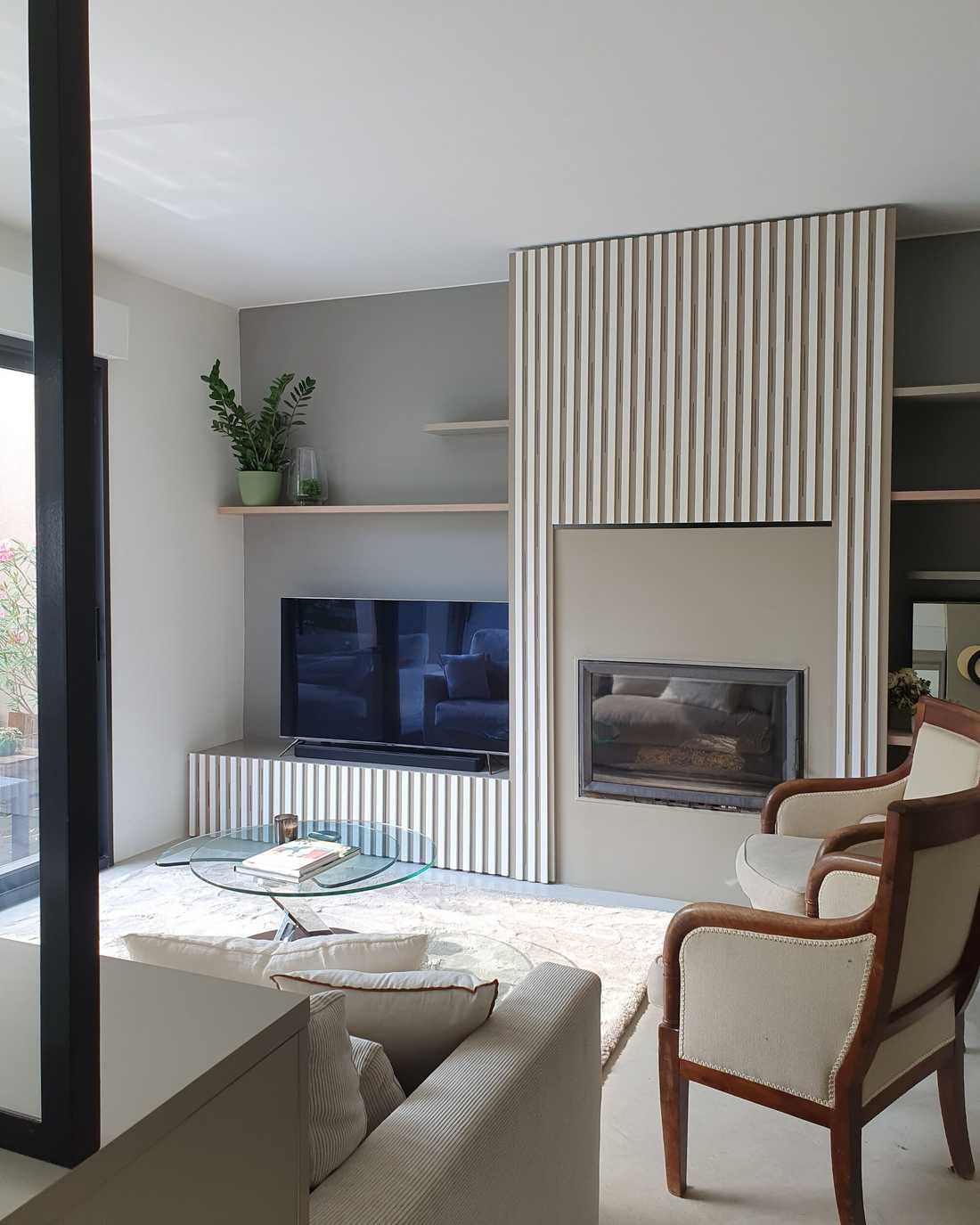 Rénovation d’une maison familiale à Meudon - le meuble TV et la cheminée habillée de bois cannelé