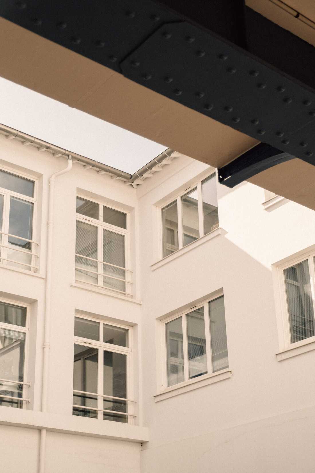 Aménagement du siège social d'une startup - Cour intérieure et façades blanches